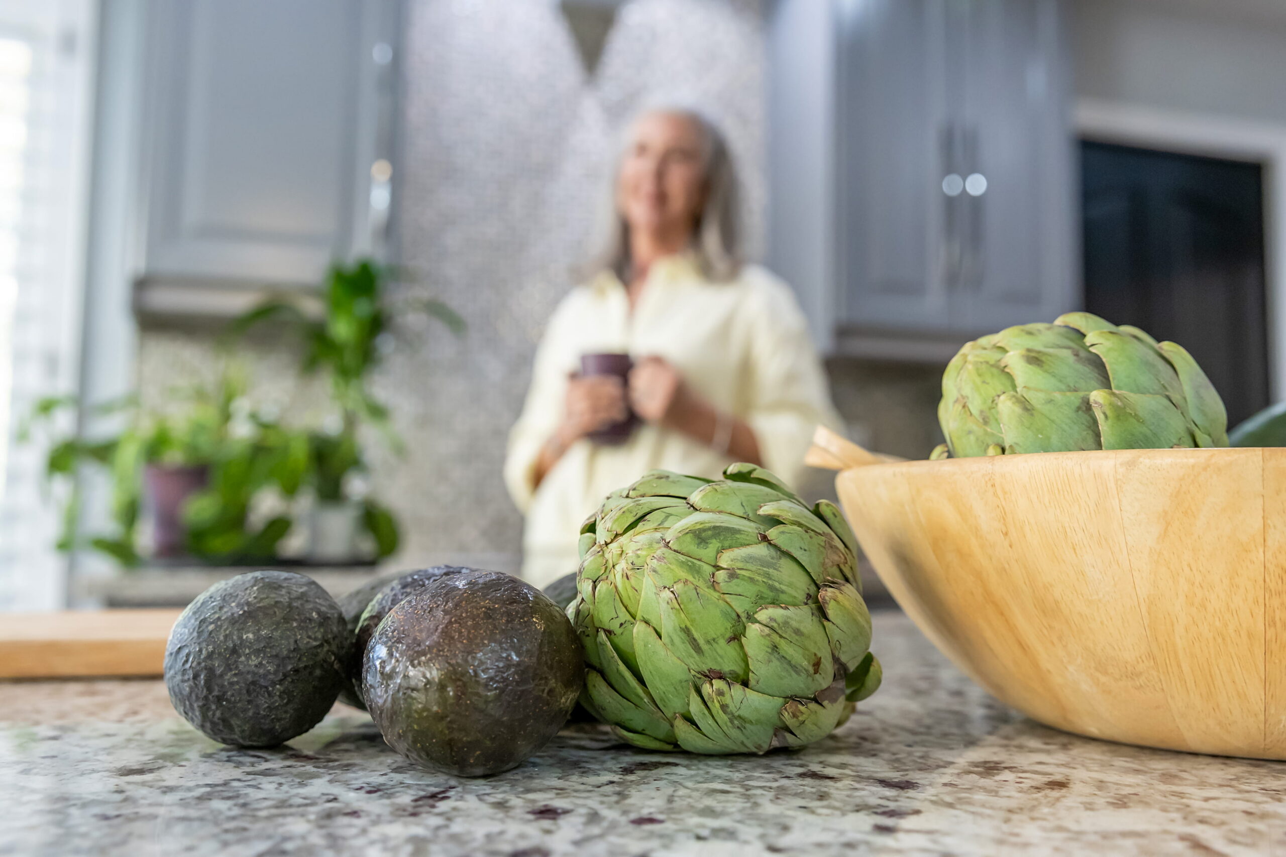 Fresh artichokes and healthy whole foods on a kitchen counter representing a natural diet transition and gut motility support after stopping semaglutide.